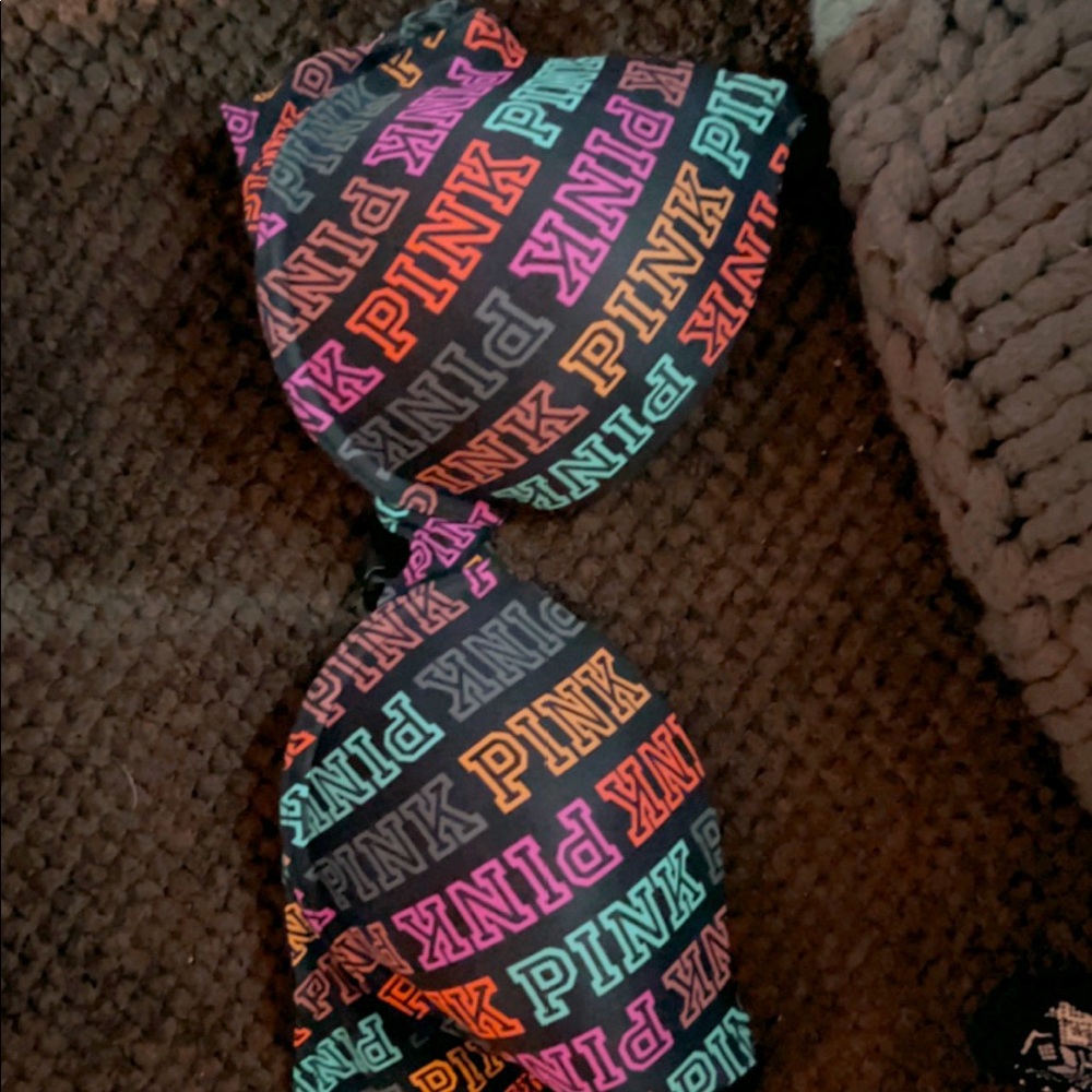 Brand new never worn Victorias Secret bra 32 DD. Black with multi color letters.